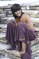 Jane Fonda sitting on a stone wall photo print