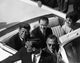 Photo print of John F. Kennedy and Jackie Kennedy in a car, capturing a historic moment.