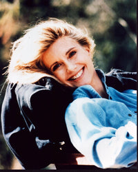 Olivia Newton-John smiling in chair photo print