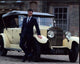 Rupert Evans in front of a yellow Rolls-Royce photo print