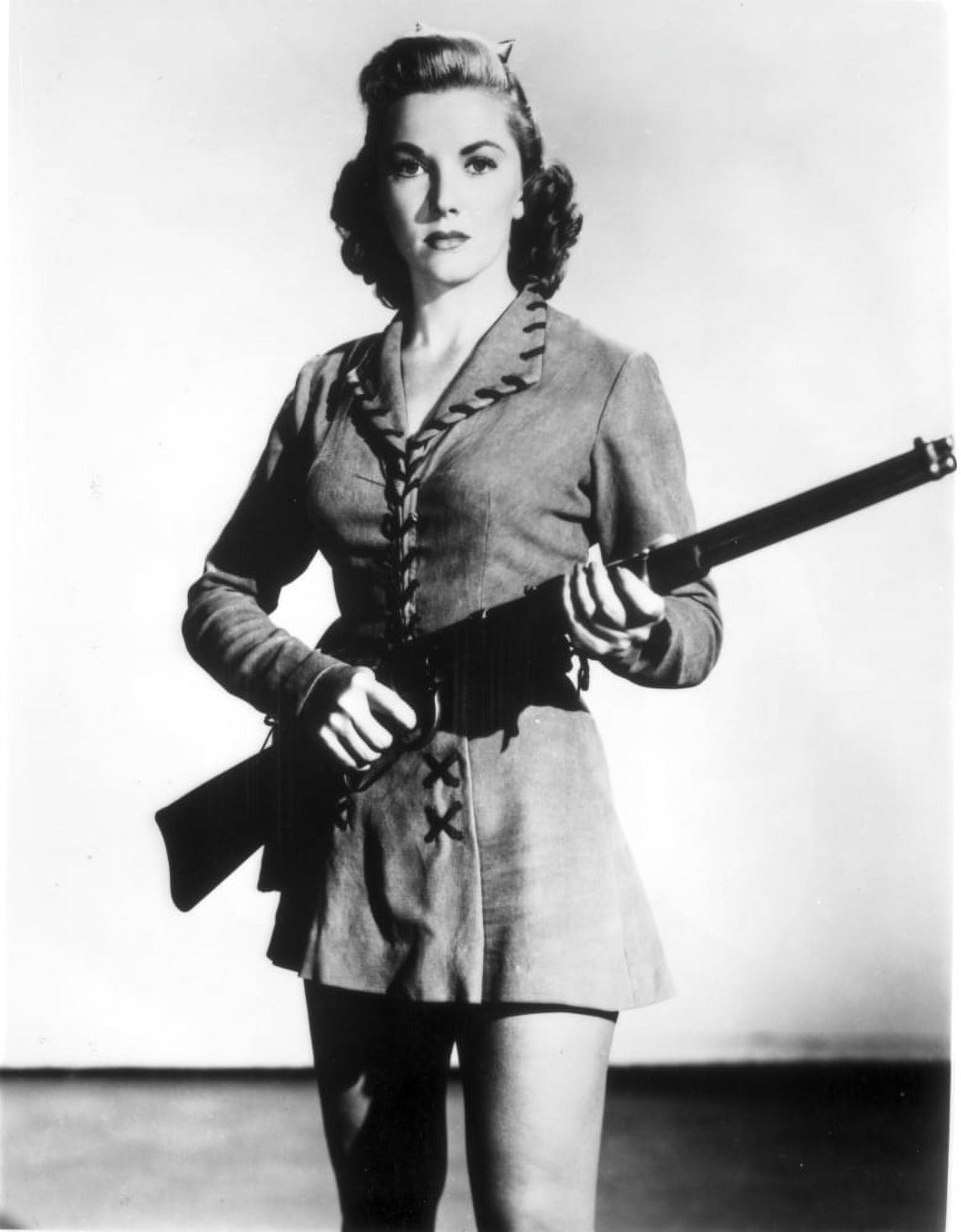 Phyllis Coates portrait carrying a rifle photo print.