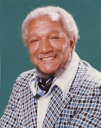 Close-up portrait photo print of Redd Foxx smiling in a coat.