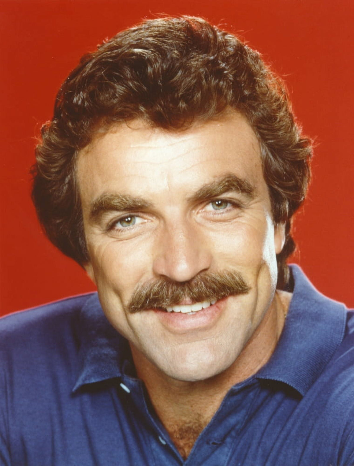 Close-up portrait photo print of Tom Selleck in blue polo shirt.