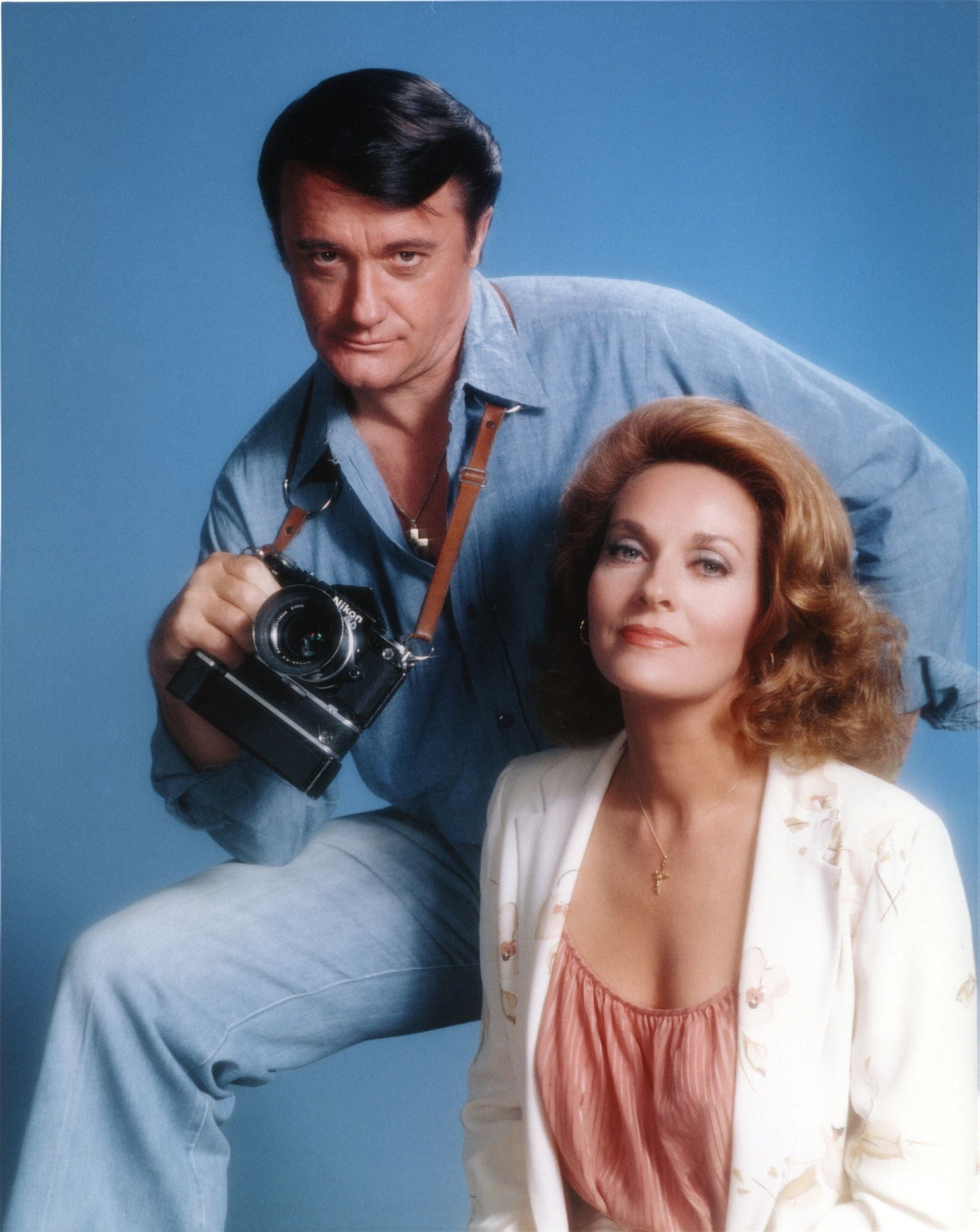 Robert Vaughn photo print featuring the actor with a camera against a blue background.
