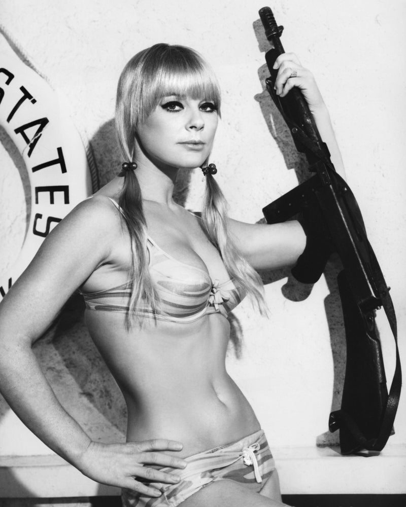 Elke Sommer holding up a gun photo print