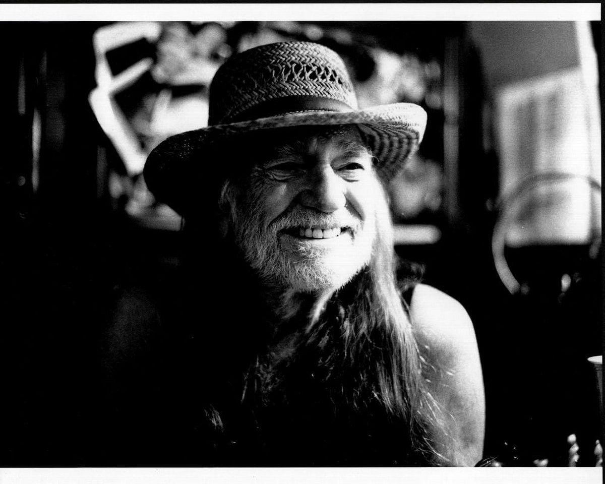 Willie Nelson black and white photo print smiling in straw hat.