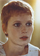 Close-up portrait of Mia Farrow wearing a white printed tank top.