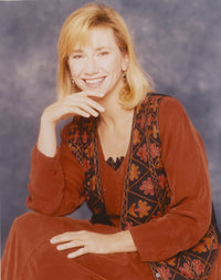 Photo print of Kathy Baker smiling in a red dress.