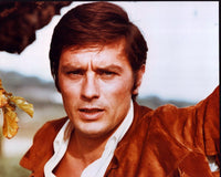 Close-up photo print of Alain Delon in a brown jacket.