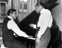 Johnny Mathis photo print featuring the artist by a piano.