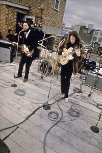 The Beatles performing on a rooftop photo print, capturing a historic music moment.