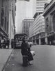 Jane Fonda sitting on a suitcase on a city street photo print