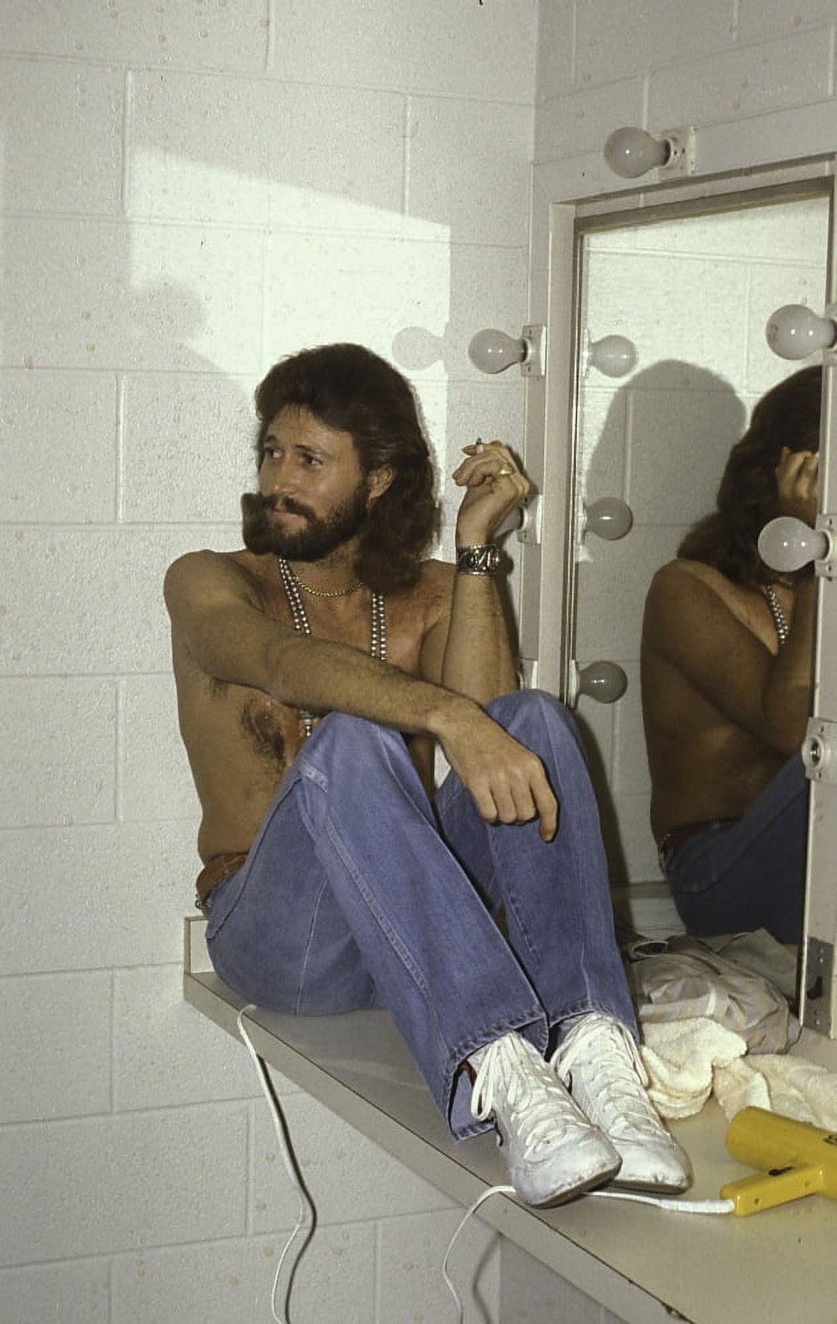 Barry Gibb sitting by a mirror photo print.