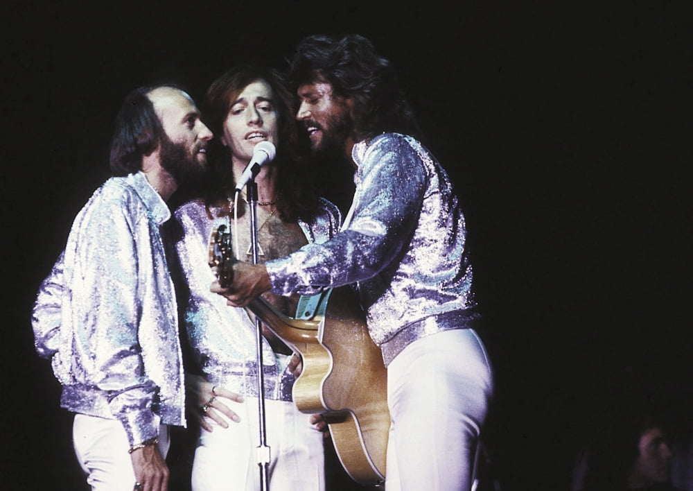 The Bee Gees live performance photo print showcasing their stage presence.