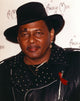Aaron Neville portrait photo print in black jacket and hat