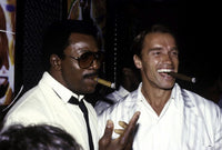Arnold Schwarzenegger and Carl Weathers Smoking Cigars Photo Print