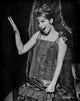 Barbra Streisand waving her hand in an elegant black dress photo print.
