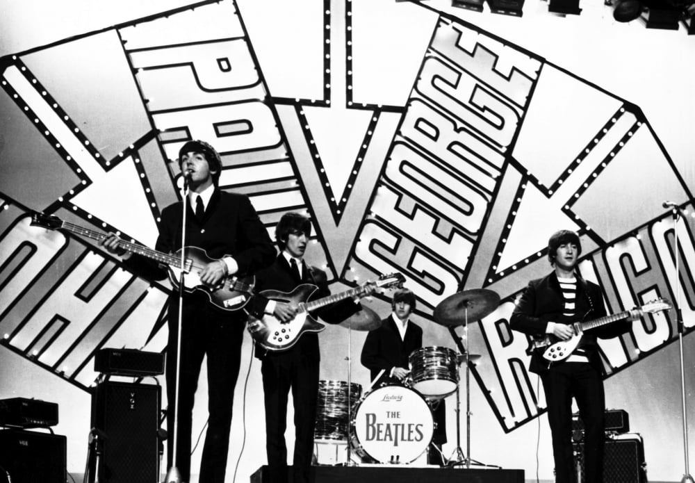The Beatles performing live photo print, capturing the essence of the iconic band.