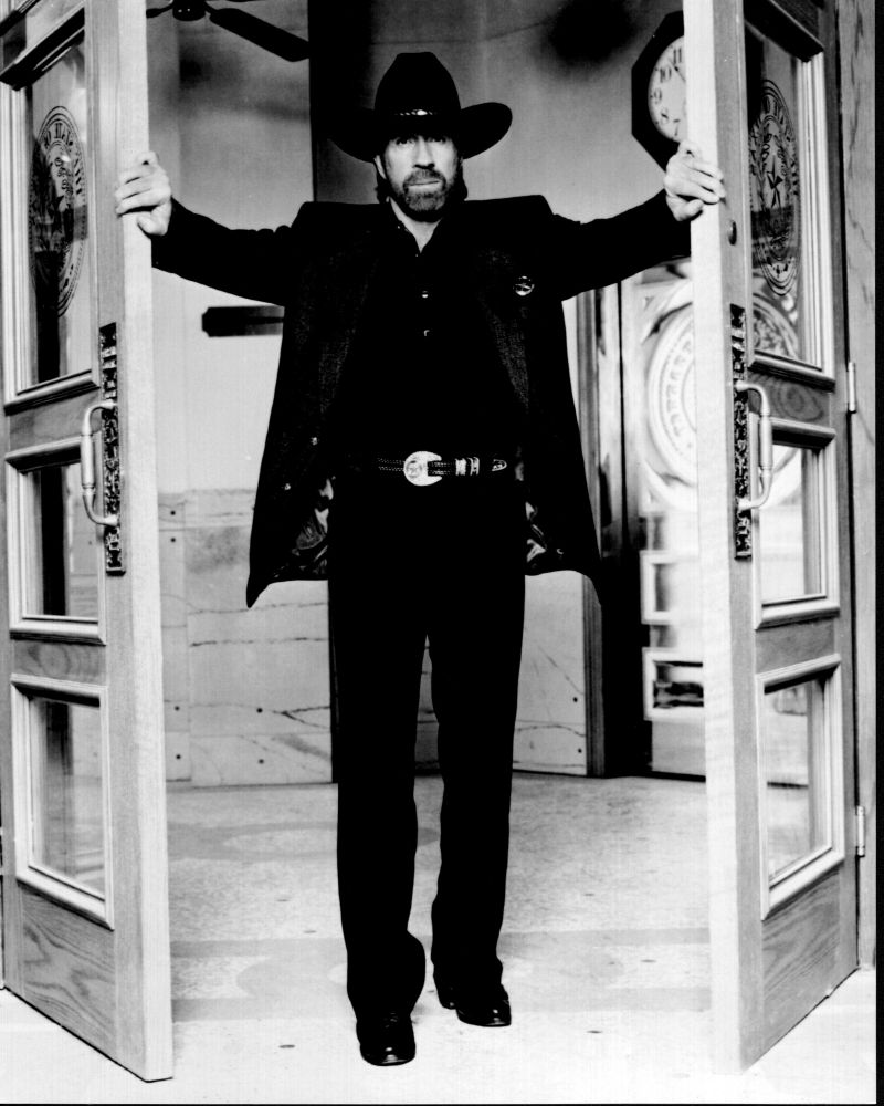 Black and white photo print of Chuck Norris opening doors in Walker Texas Ranger.