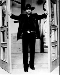 Black and white photo print of Chuck Norris opening doors in Walker Texas Ranger.