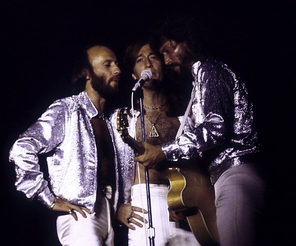The Bee Gees live performance photo print showcasing the iconic band on stage.