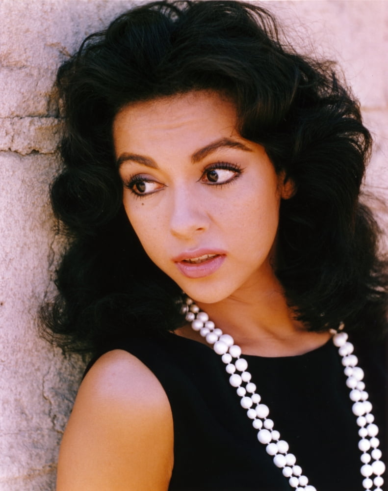 Rita Moreno looking away in an elegant black dress with necklace photo print.