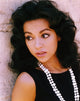 Rita Moreno looking away in an elegant black dress with necklace photo print.