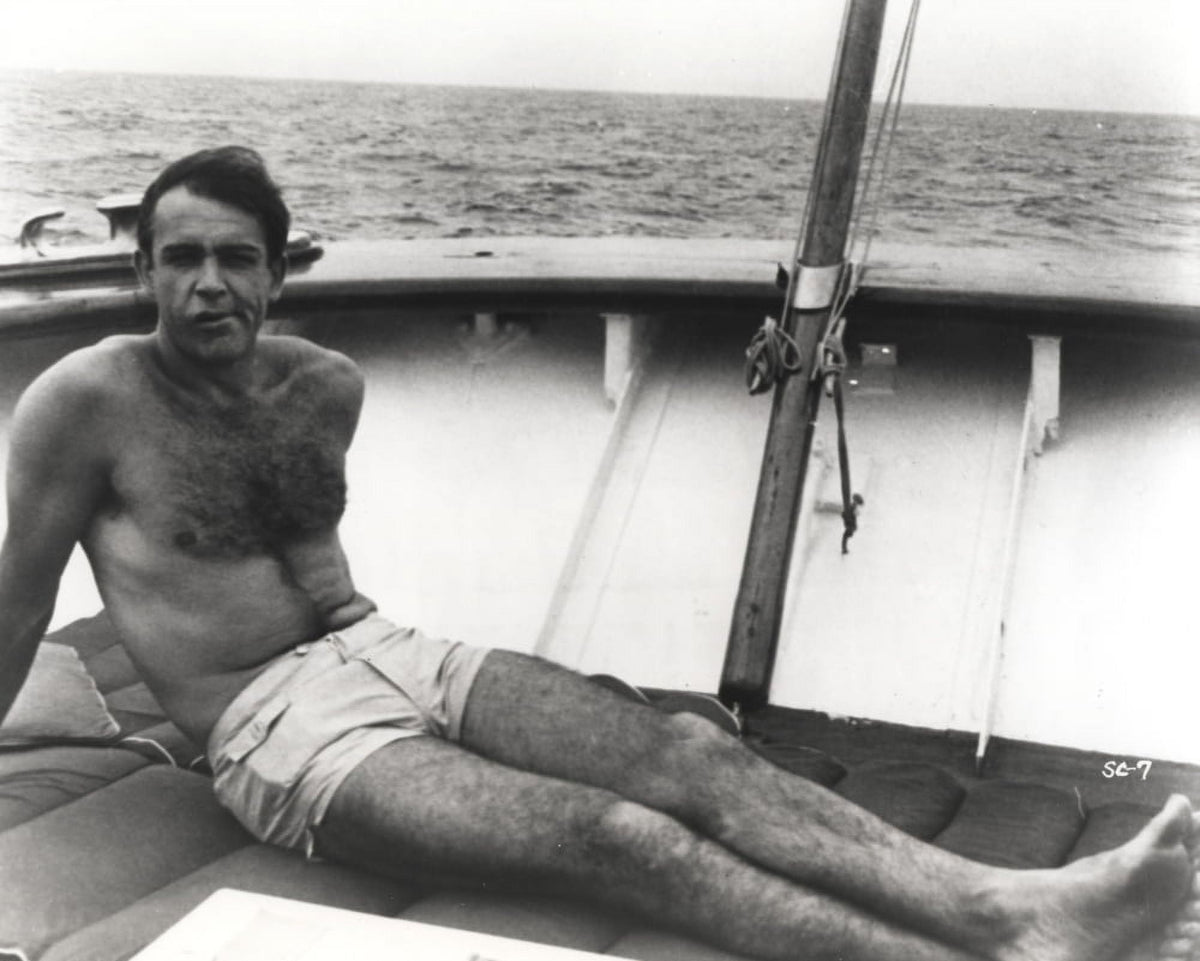 Sean Connery sunbathing on a boat photo print.