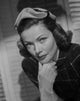 Gene Tierney photo print in white gloves, classic Hollywood elegance.