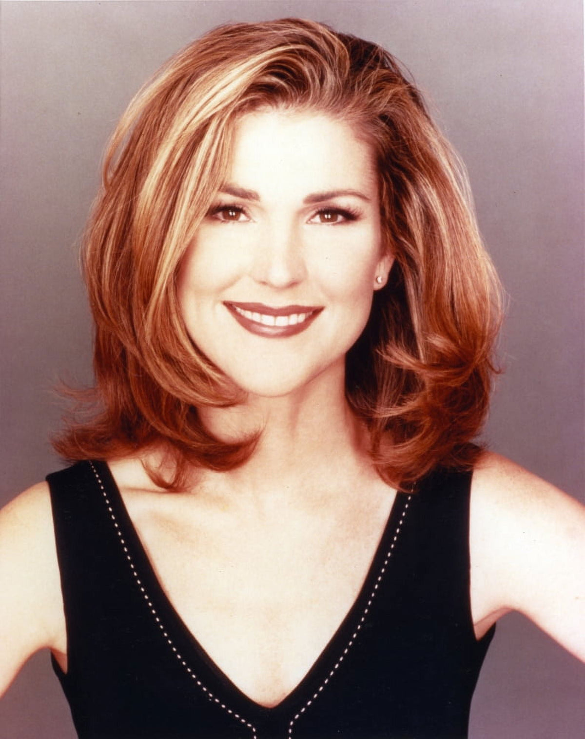 Close-up portrait photo print of Peri Gilpin smiling.