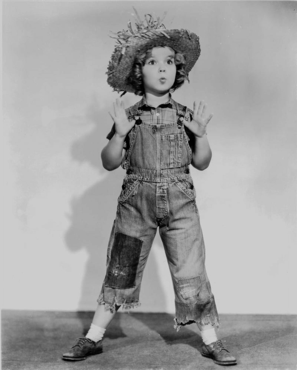 Shirley Temple dancing in jumper suit with overalls and straw hat photo print