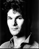 Black and white photo print of Patrick Swayze in a denim shirt.