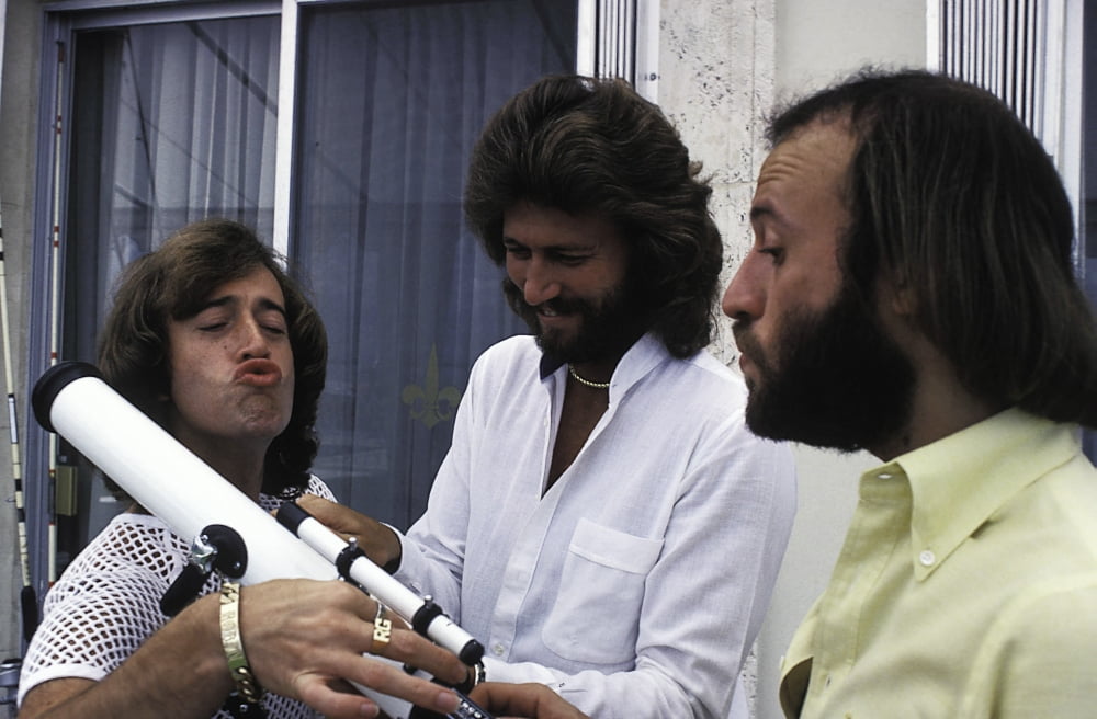 The Bee Gees Photo Print featuring iconic musicians with telescope.