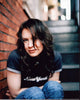 Renée Zellweger sitting on steps in black shirt and jeans photo print.