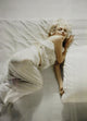Marilyn Monroe lying on a bed photo print in vintage style.