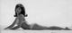 Raquel Welch lying on beach in a bikini photo print