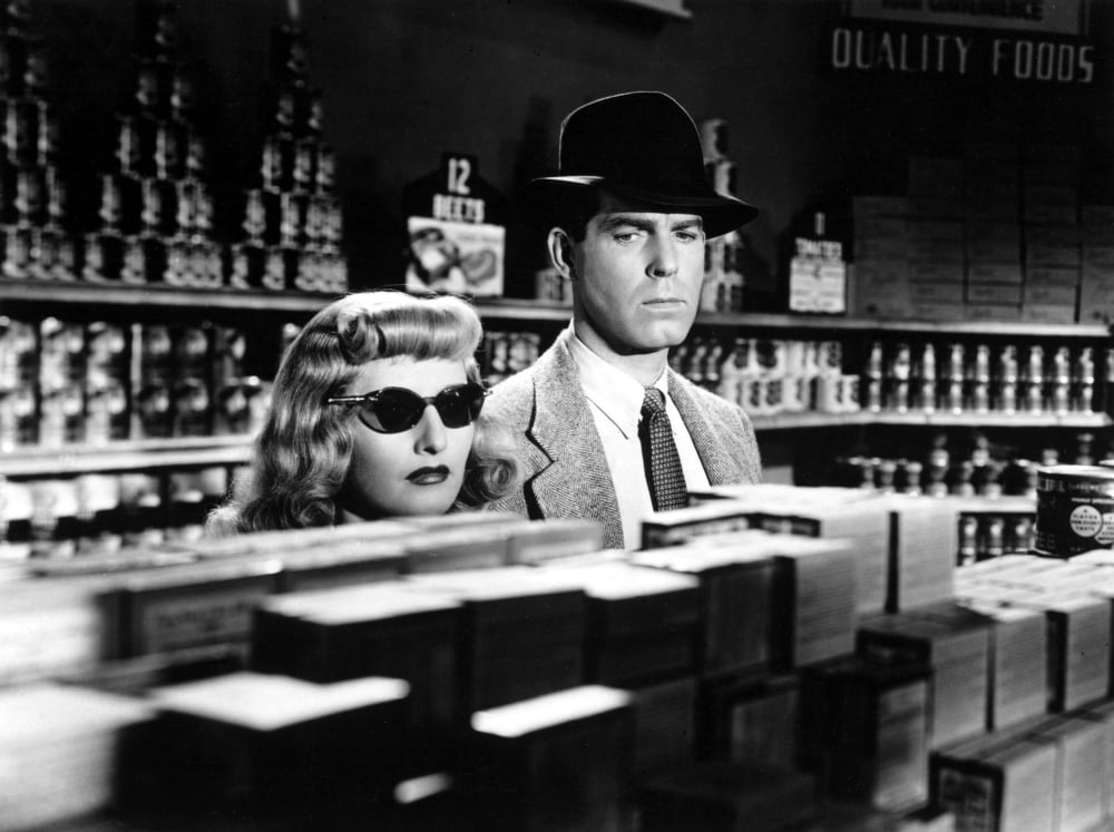 Double Indemnity movie poster featuring Barbara Stanwyck and Fred MacMurray.