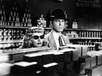 Double Indemnity movie poster featuring Barbara Stanwyck and Fred MacMurray.
