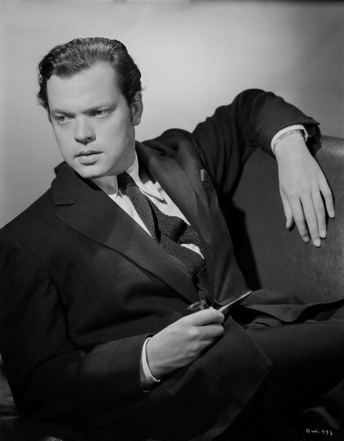 Orson Welles reclining in coat and tie photo print