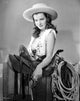 Ella Raines photo print in cowgirl outfit holding a pistol