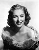 Eleanor Parker smiling in an off-shoulder dress photo print