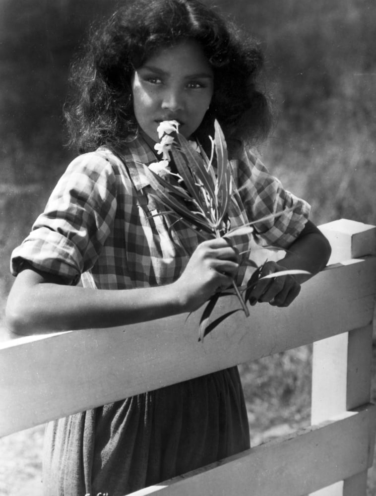 Jennifer Jones leaning in a checkered top photo print