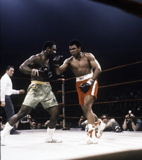 Muhammad Ali fighting Joe Frazier photo print, iconic boxing moment.