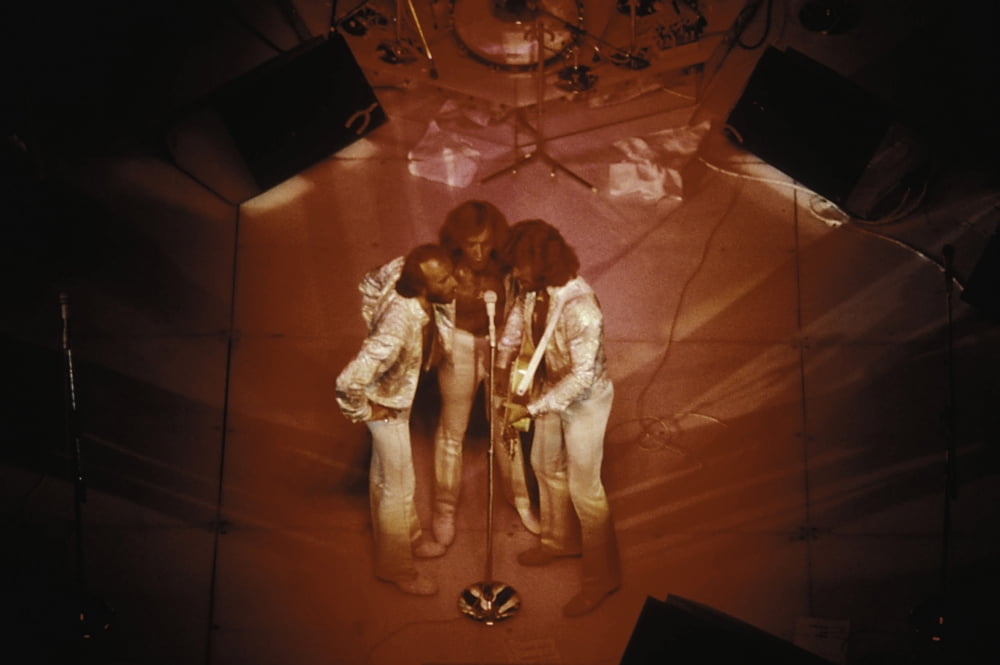 The Bee Gees live performance photo print capturing their iconic stage presence.