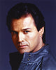 Close-up portrait photo print of Michael Nader in a black leather jacket.