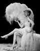 Lucille Ball seated with fan photo print capturing classic television charm.