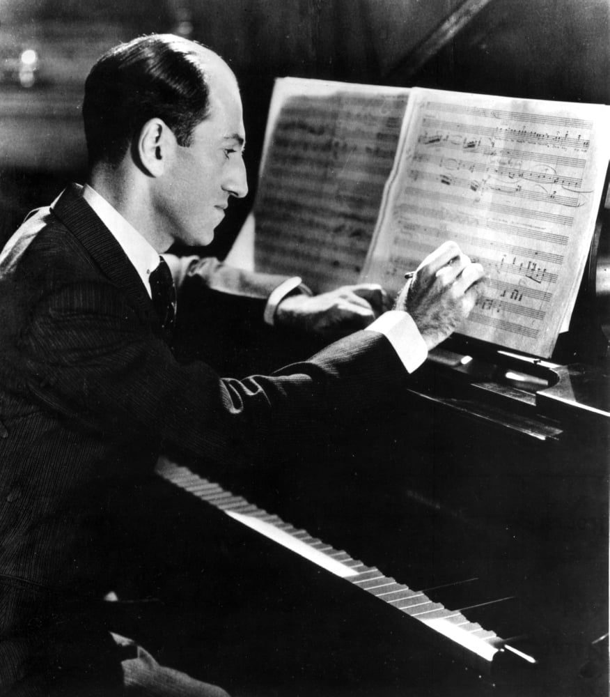 George Gershwin writing at his piano photo print
