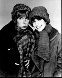 Black and white photo print of Penny Marshall and Cindy Williams in coats and hats from Laverne & Shirley.