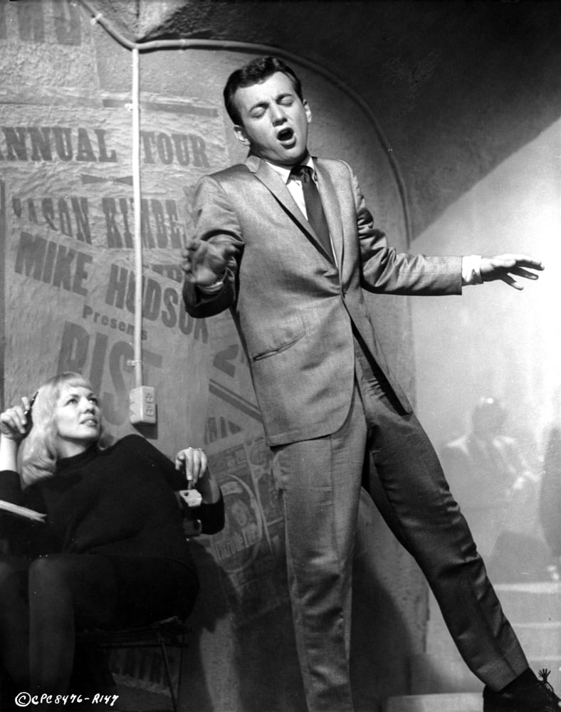 Bobby Darin singing with a woman looking on - Photo Print