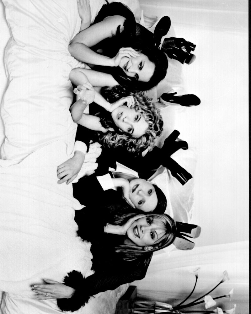 Black and white photo print of Sex And The City characters on bed.